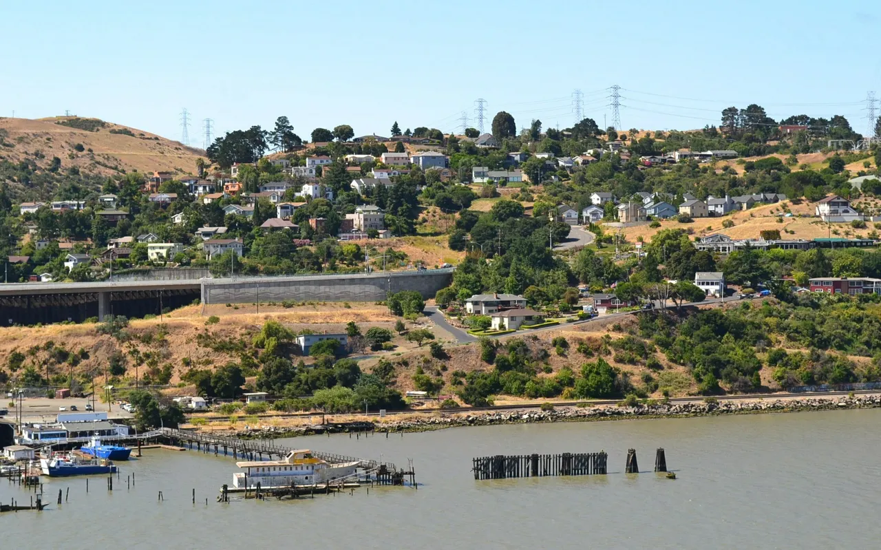 Crockett houses spread across a hillside above the Carquinez Strait shoreline.