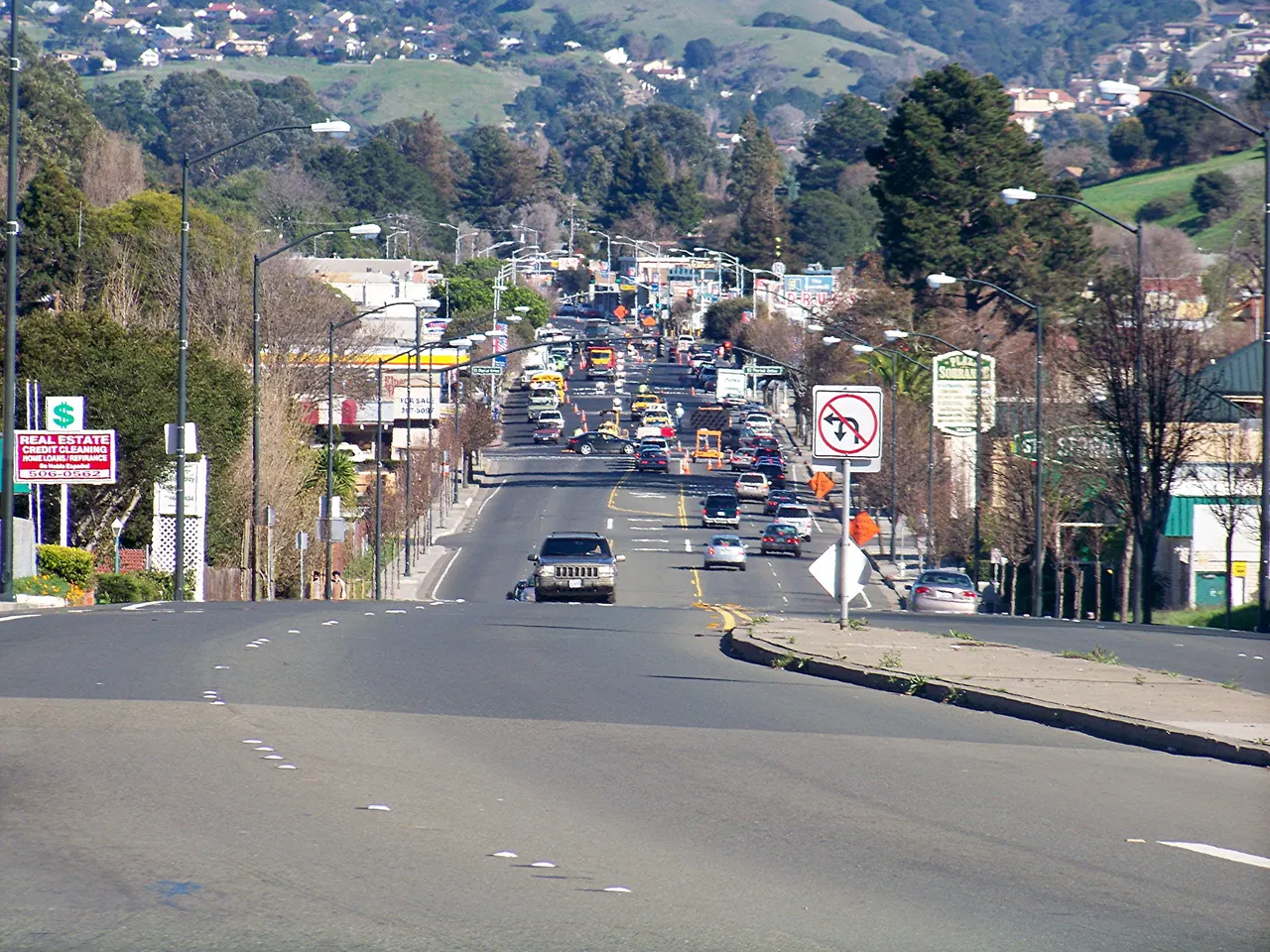 San Pablo Dam Road running east through shops and homes in El Sobrante.