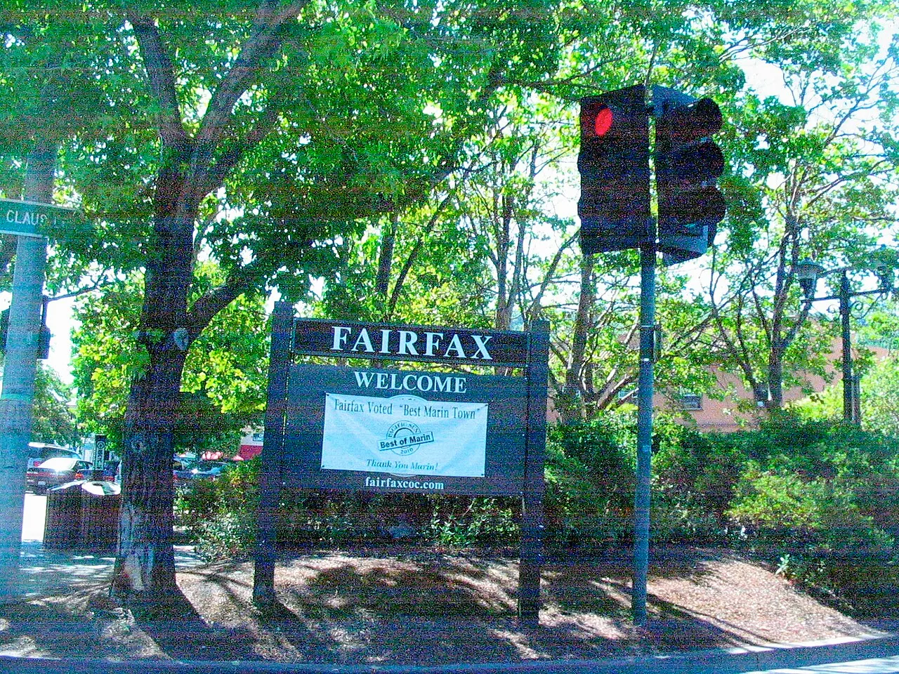 The Fairfax welcome sign beneath leafy trees.