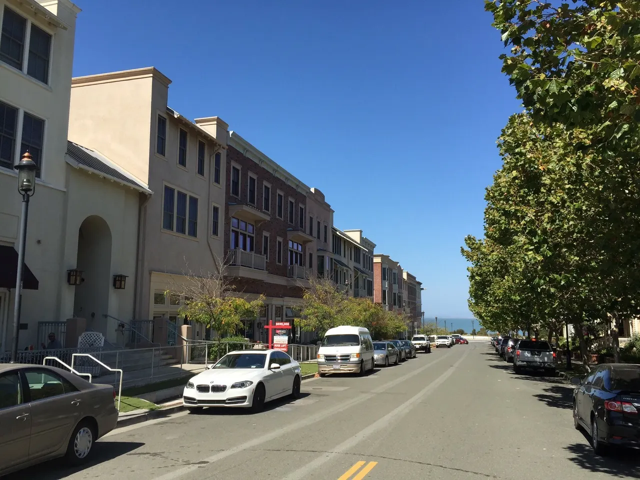 Buildings and parked cars along Railroad Avenue in Hercules, viewed looking north.