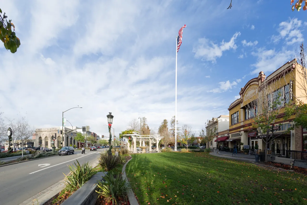Downtown Livermore streets, storefronts, and a landscaped plaza beneath a bright sky.