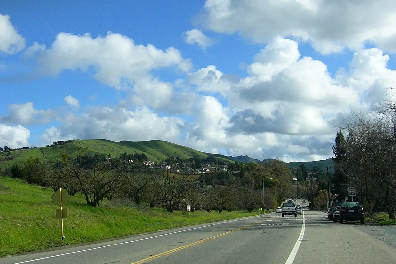 The intersection of Camino Ricardo and Moraga Way in Moraga, with green hills in the distance.