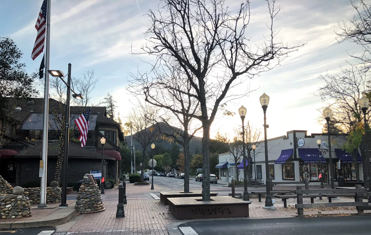 Downtown Morgan Hill storefronts and plaza seating, with El Toro in the background.