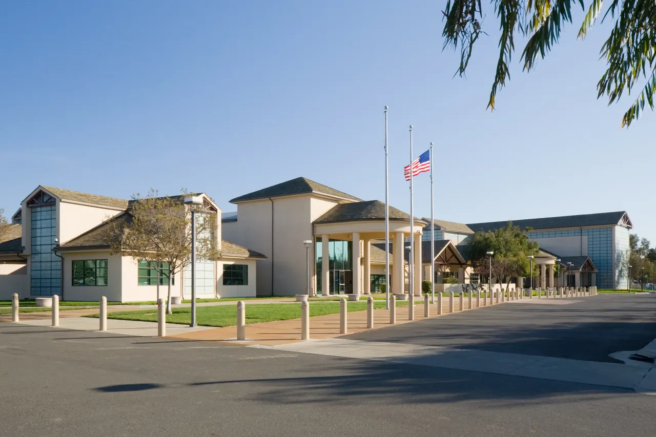 The Silliman Activity and Family Aquatic Center in Newark, with palm trees and an American flag outside.