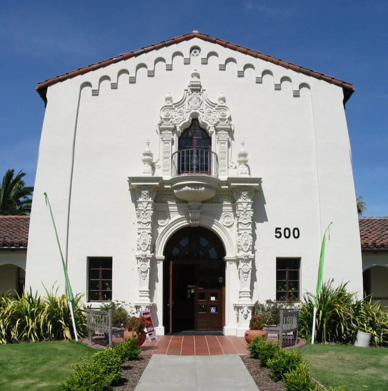 The white facade and ornate entry of the historic Novato City Hall.