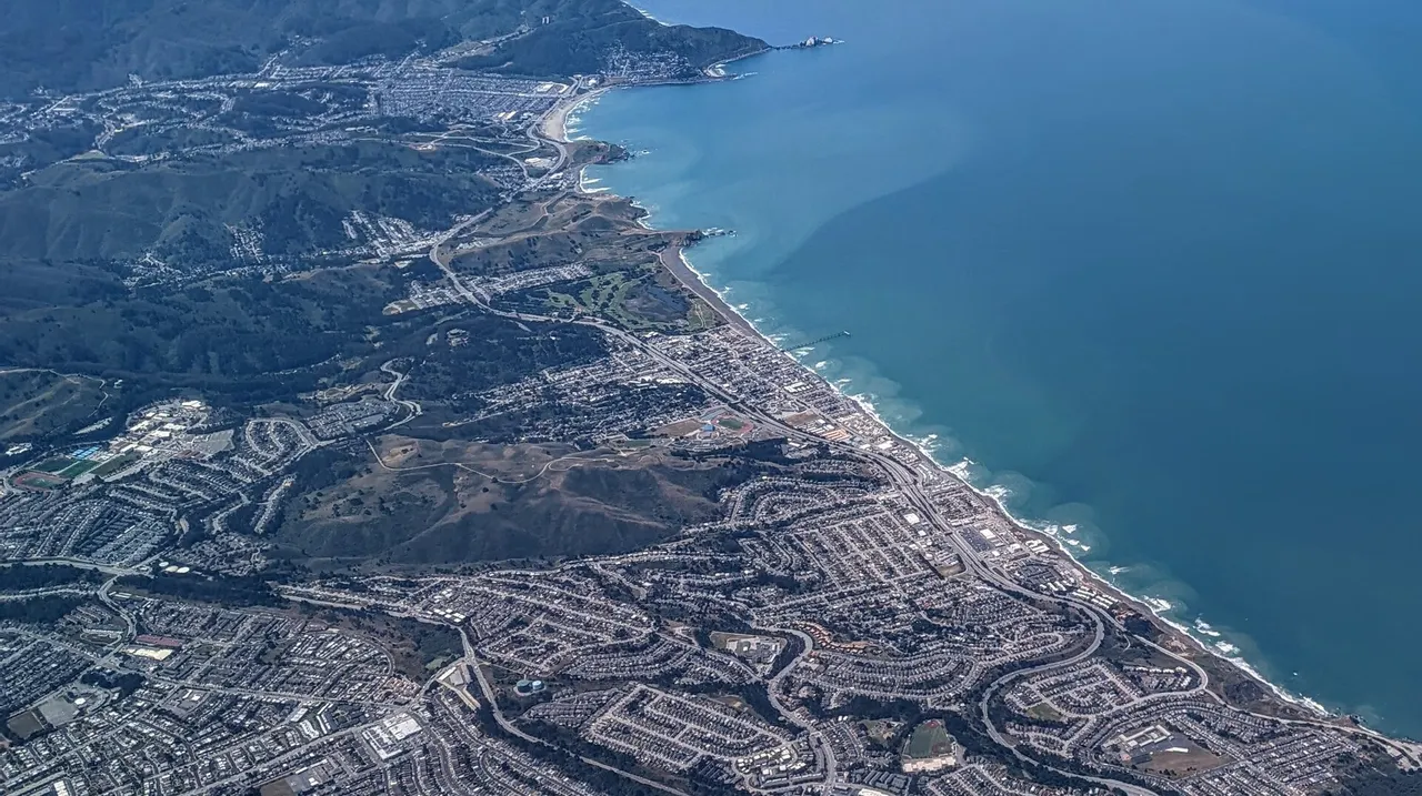 Aerial view of Pacifica neighborhoods along the Pacific Ocean.