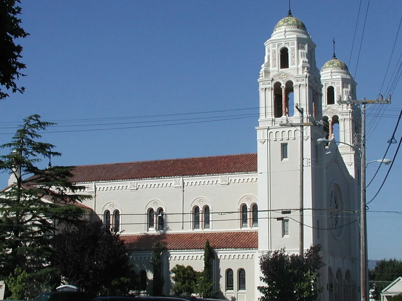 St. Vincent de Paul Church in Petaluma, with twin bell towers against a blue sky.