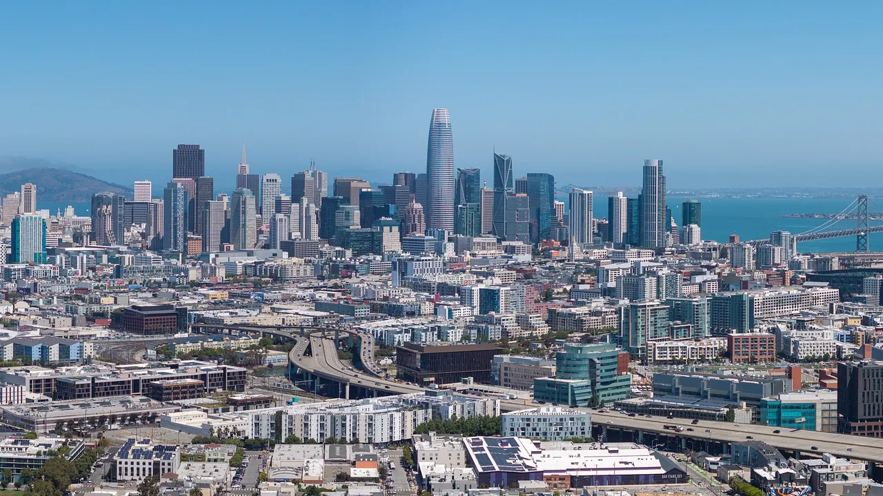 San Francisco skyline and Salesforce Tower seen above the city streets, with the Bay beyond.