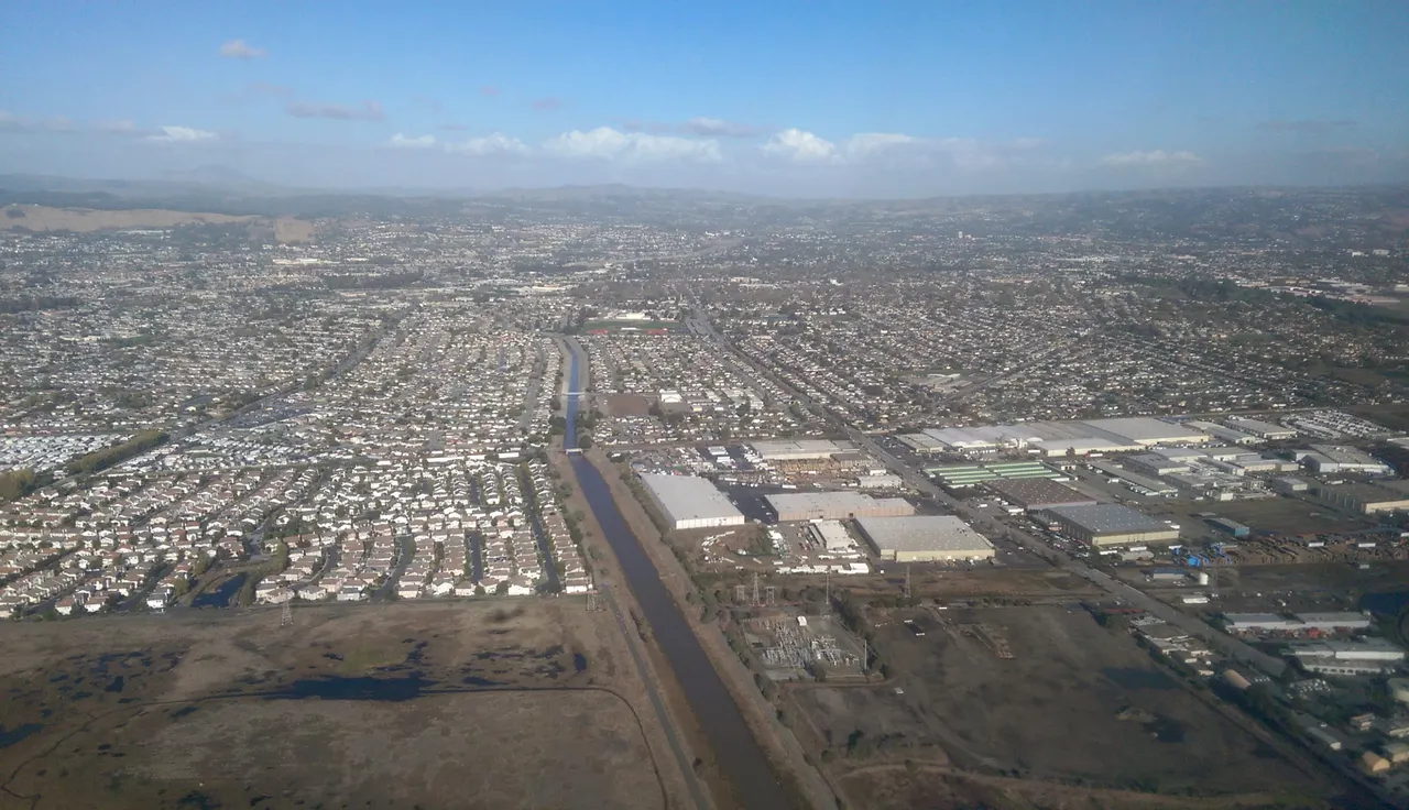An aerial view over San Lorenzo neighborhoods, streets and industrial buildings.