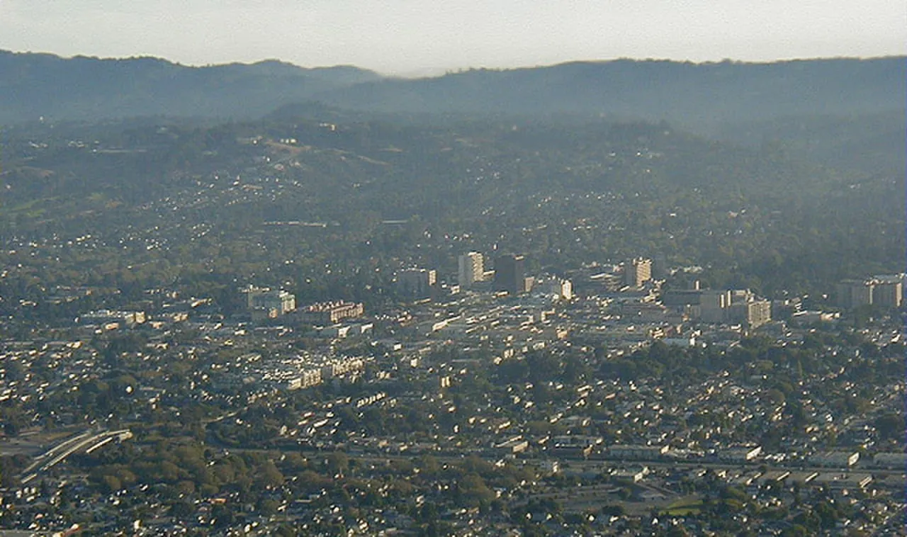 Aerial view across San Mateo neighborhoods toward the Peninsula hills.