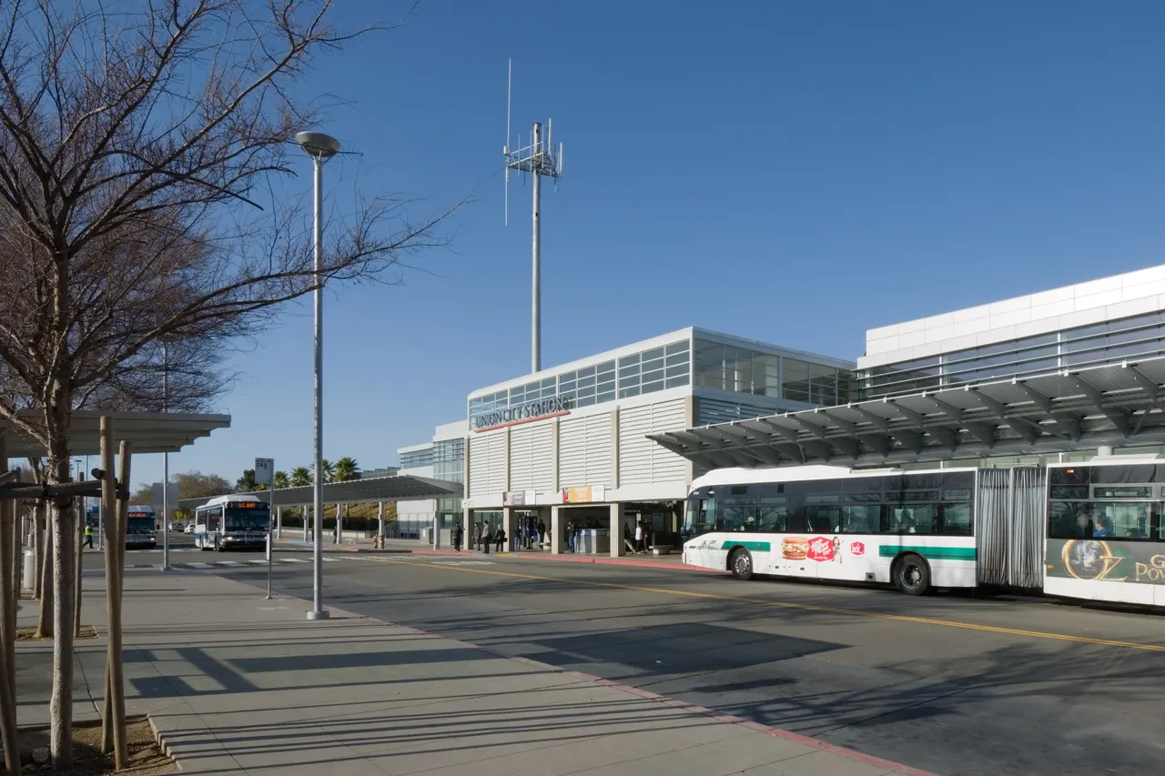 The entrance of Union City BART station beneath a clear blue sky.