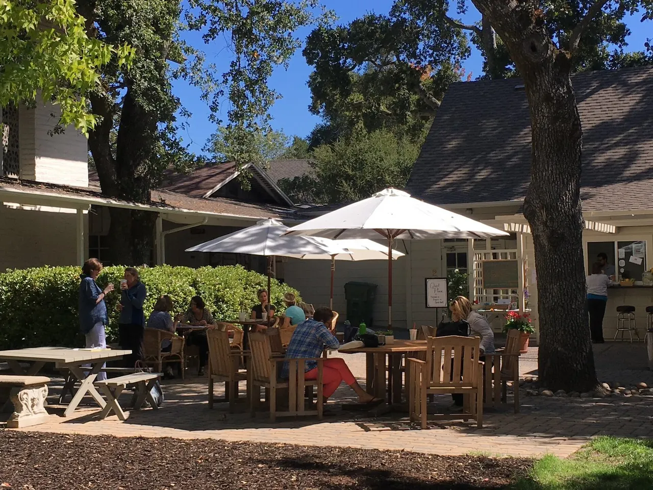 Outdoor tables and umbrellas at the Village Hub in downtown Woodside.